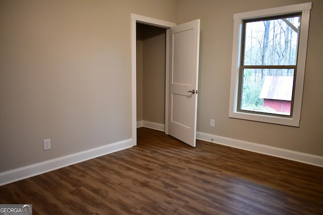 spare room with dark hardwood / wood-style flooring