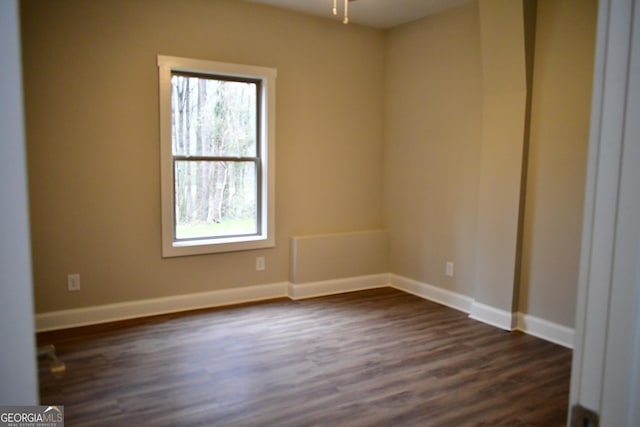 spare room with ceiling fan and dark hardwood / wood-style flooring