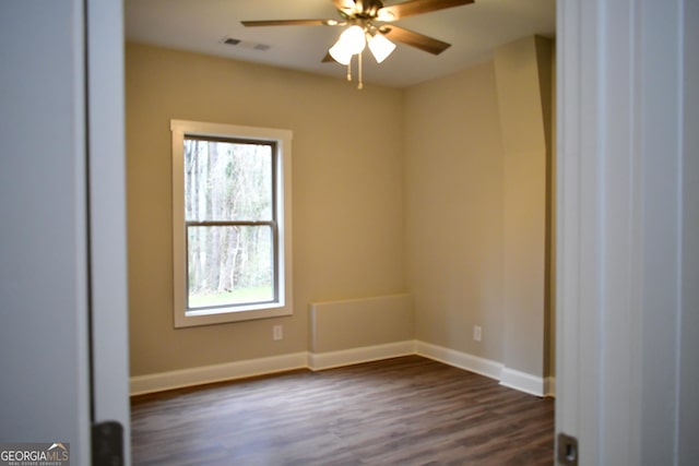 spare room with ceiling fan and dark hardwood / wood-style floors