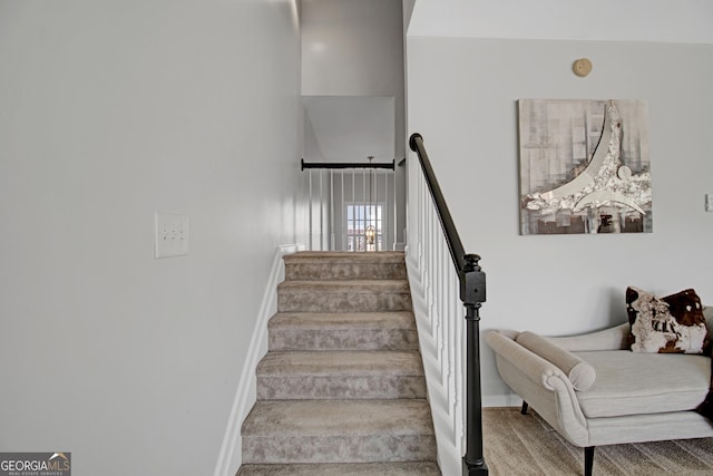 staircase with baseboards and carpet flooring