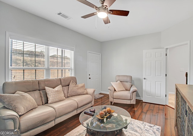 living area featuring ceiling fan, wood finished floors, visible vents, and baseboards