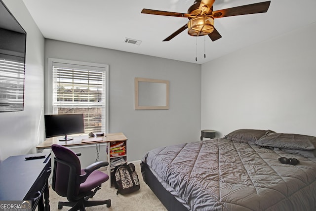 carpeted bedroom with ceiling fan and visible vents