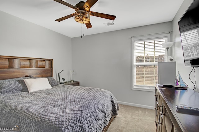 bedroom with visible vents, baseboards, a ceiling fan, and light colored carpet