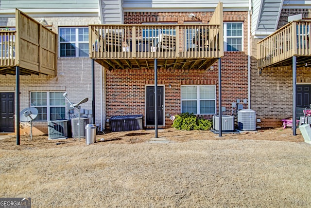 back of property with brick siding and central air condition unit