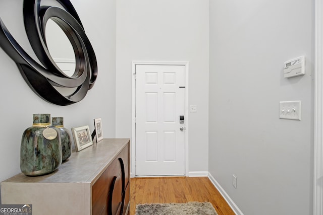 entryway with light wood-style floors and baseboards