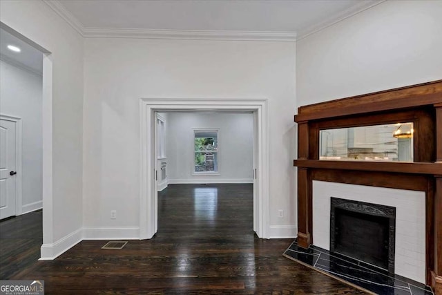 unfurnished living room featuring dark hardwood / wood-style flooring and crown molding