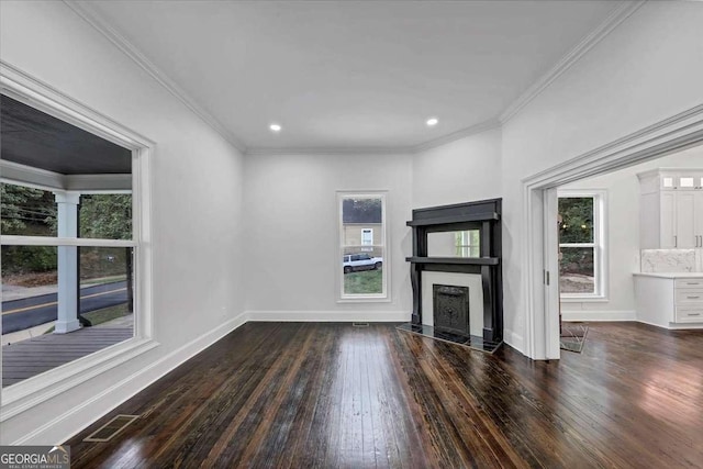 unfurnished living room with dark wood-type flooring, a high end fireplace, and crown molding