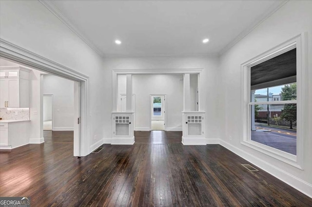 unfurnished living room featuring dark wood-type flooring and crown molding