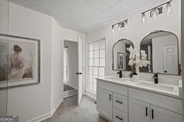 3308 Wildwood Dr SW, Marietta, GA 30060 - full bath featuring marble finish floor, double vanity, baseboards, and a sink