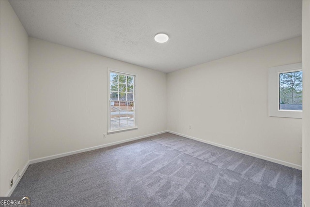 3308 Wildwood Dr SW, Marietta, GA 30060 - empty room with carpet flooring, baseboards, and a textured ceiling