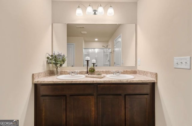 bathroom with vanity and a shower with shower door