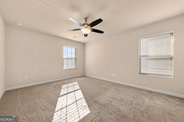 carpeted empty room featuring ceiling fan