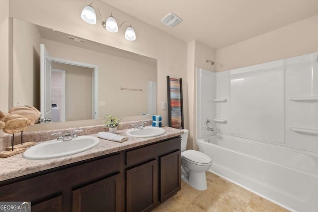 full bathroom featuring shower / bath combination, vanity, and toilet