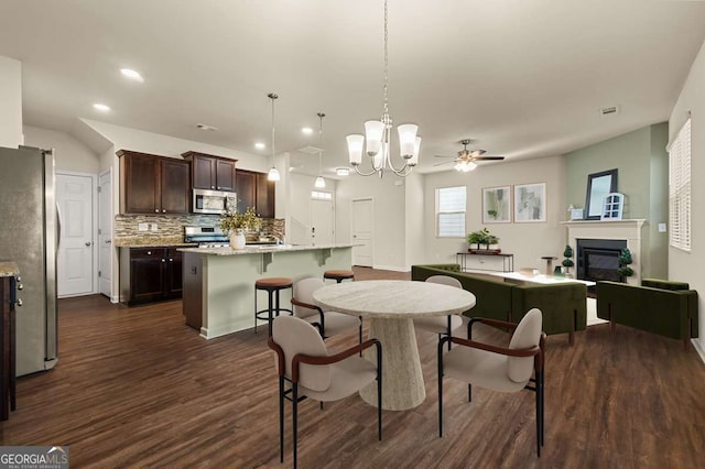 dining space featuring ceiling fan and dark hardwood / wood-style flooring