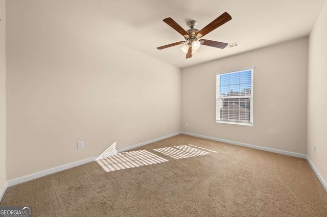 carpeted spare room featuring ceiling fan