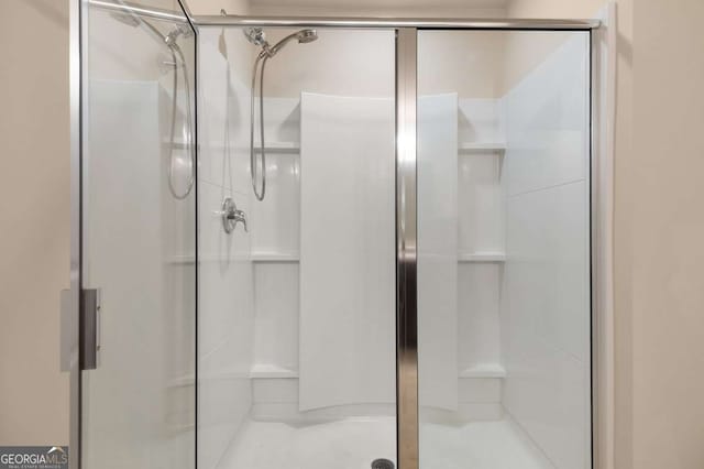 bathroom featuring a shower with door