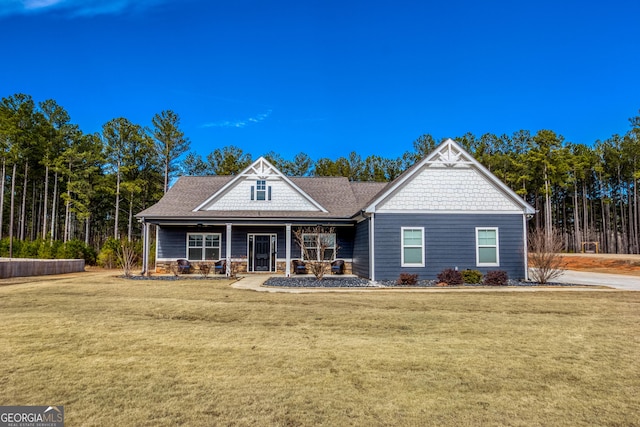 view of front of property featuring a front lawn and a porch