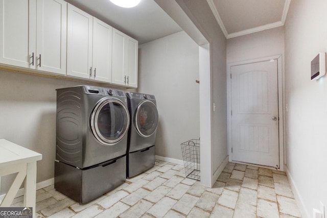 laundry area featuring cabinets, ornamental molding, and separate washer and dryer