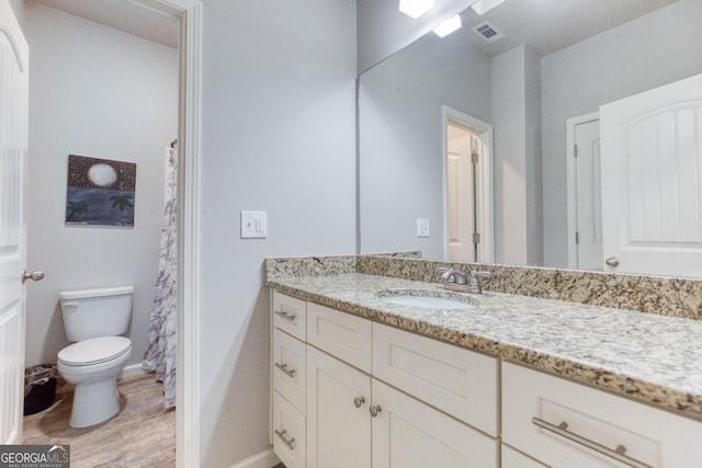 bathroom with vanity and toilet