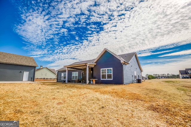 view of front of home featuring a front yard and central air condition unit