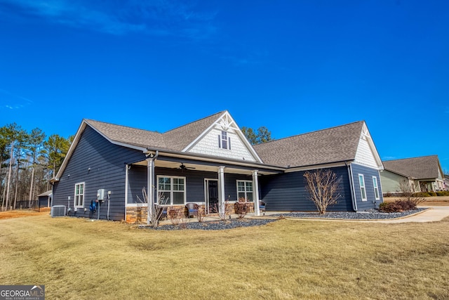 view of front of home featuring central AC, a front yard, and ceiling fan