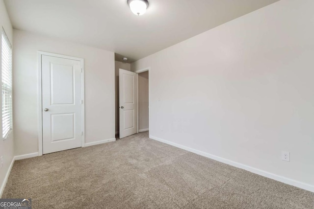 unfurnished bedroom with light colored carpet