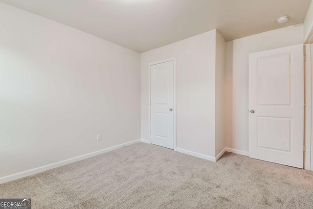 unfurnished bedroom with light colored carpet