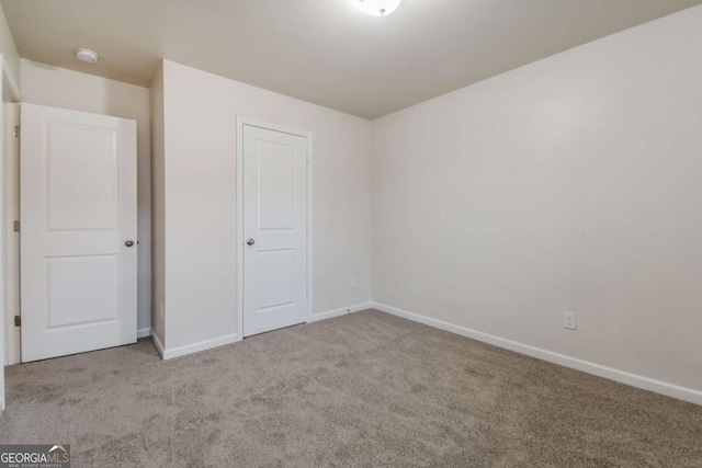 unfurnished bedroom featuring light carpet