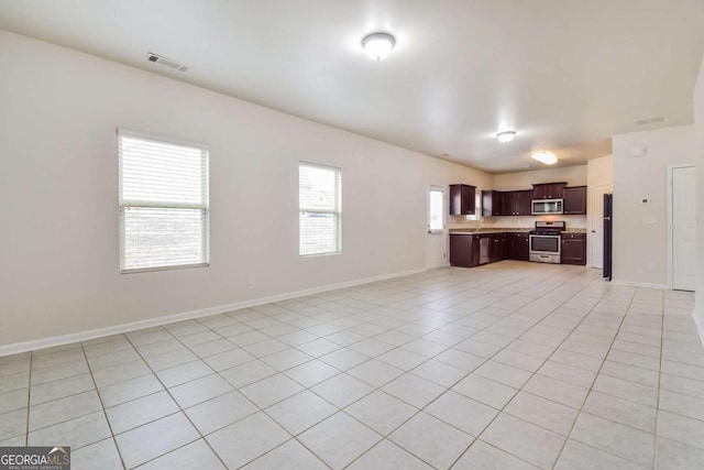 unfurnished living room featuring light tile patterned floors