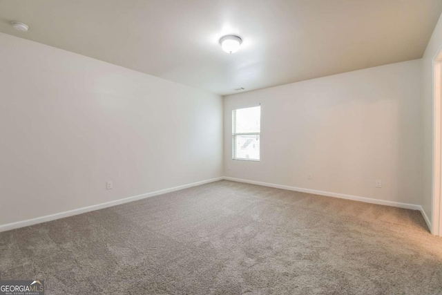 spare room featuring carpet