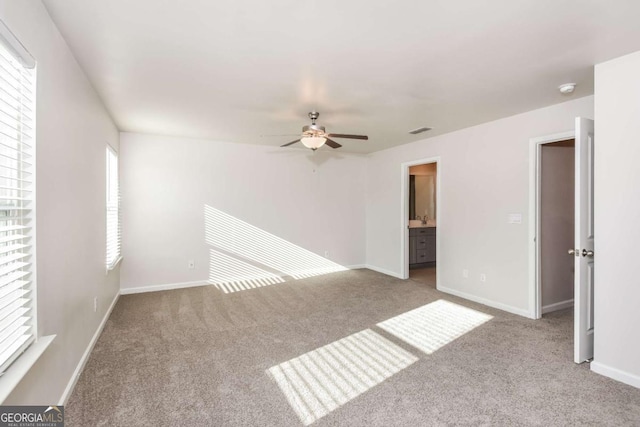 spare room featuring light carpet and ceiling fan