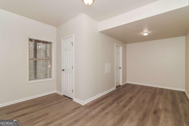 unfurnished room with dark hardwood / wood-style floors