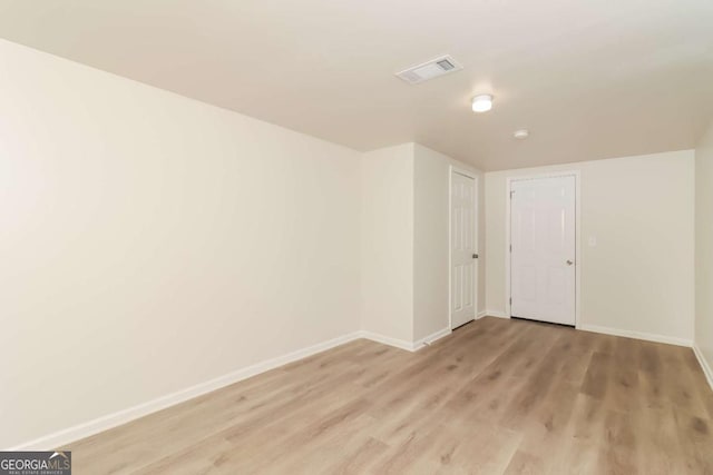 spare room with light hardwood / wood-style floors