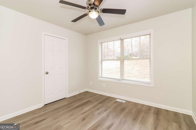 spare room with ceiling fan and hardwood / wood-style floors