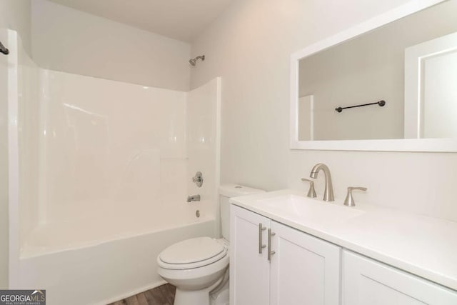 full bathroom featuring vanity, wood-type flooring, shower / bathing tub combination, and toilet