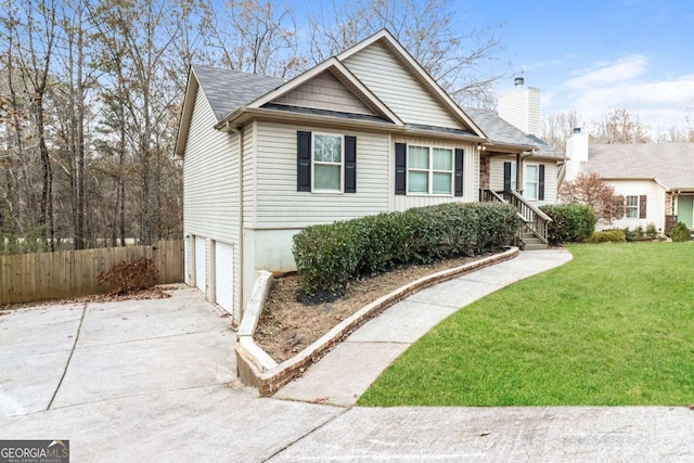 view of front facade with a garage and a front yard