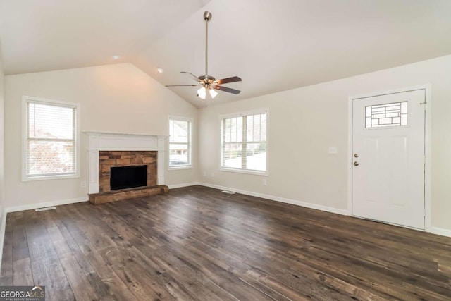 unfurnished living room with a fireplace, dark wood-type flooring, ceiling fan, and vaulted ceiling