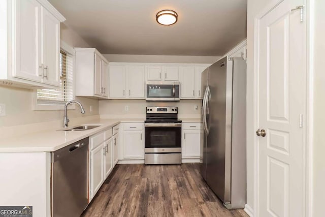 kitchen featuring white cabinetry, appliances with stainless steel finishes, dark hardwood / wood-style floors, and sink