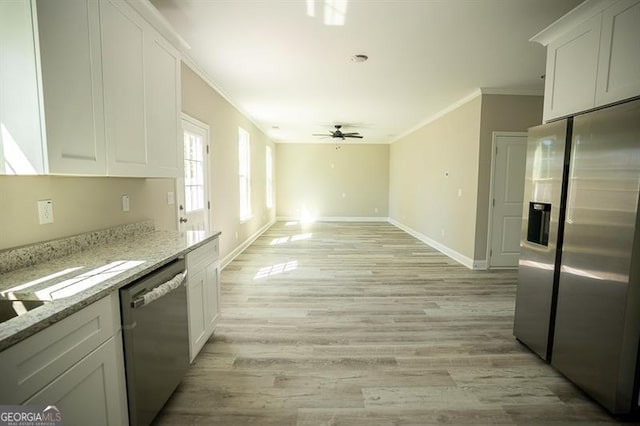 kitchen featuring appliances with stainless steel finishes, white cabinetry, ceiling fan, light stone counters, and light hardwood / wood-style flooring