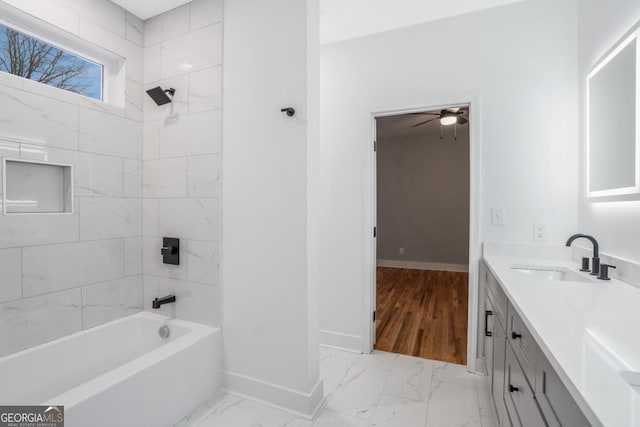 bathroom featuring vanity and tiled shower / bath