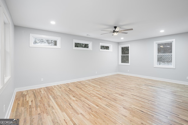 spare room with ceiling fan and light wood-type flooring