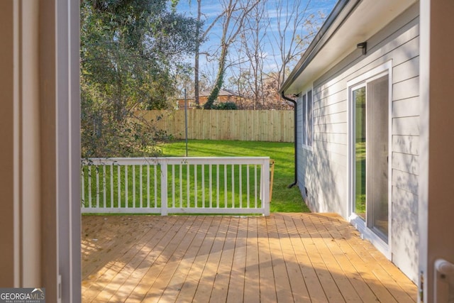 wooden deck featuring a yard