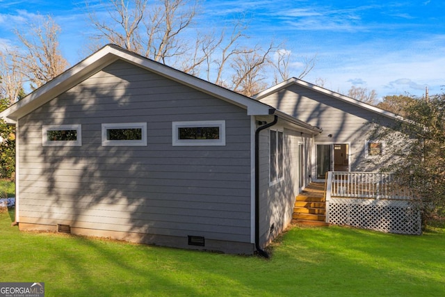 view of home's exterior featuring a deck and a lawn