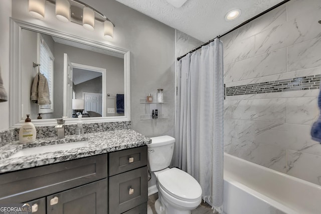 full bathroom featuring vanity, toilet, shower / tub combo, and a textured ceiling