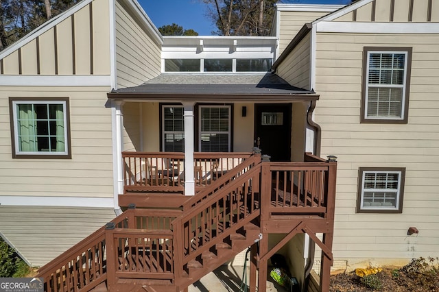 rear view of property featuring covered porch