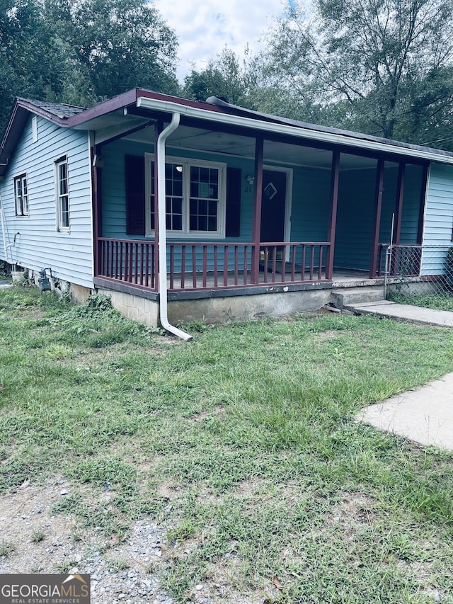 view of front of house featuring a front yard and a porch