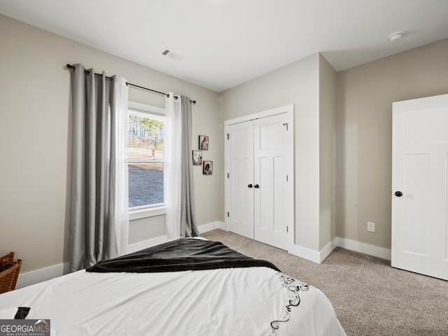 bedroom with light carpet and a closet