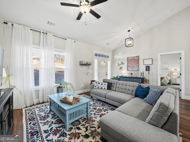 living room featuring lofted ceiling, dark hardwood / wood-style flooring, and ceiling fan