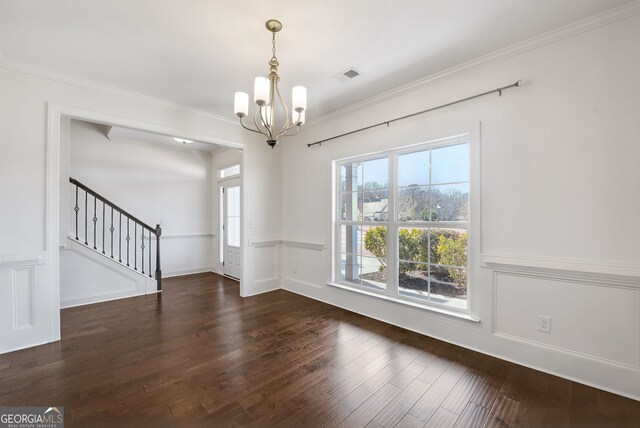 interior space featuring ornamental molding, dark wood-type flooring, and a chandelier