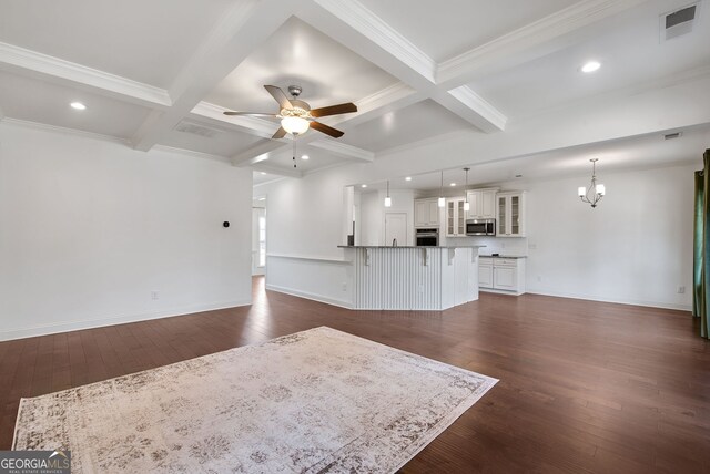 unfurnished living room featuring beam ceiling, coffered ceiling, ceiling fan with notable chandelier, and dark hardwood / wood-style flooring